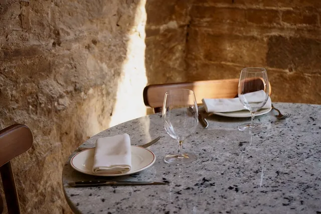 A laid table against the restaurant's stone wall